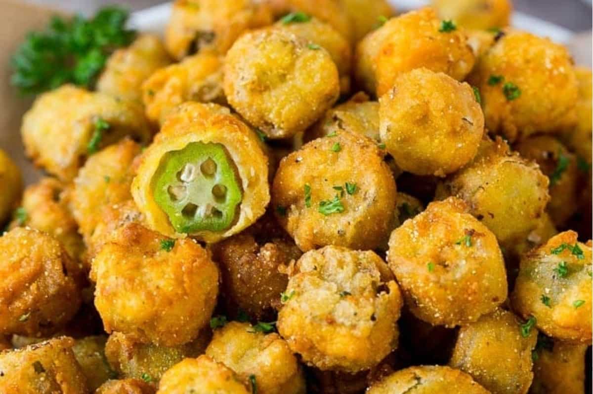 A close-up view of breaded and fried okra garnished with parsley.