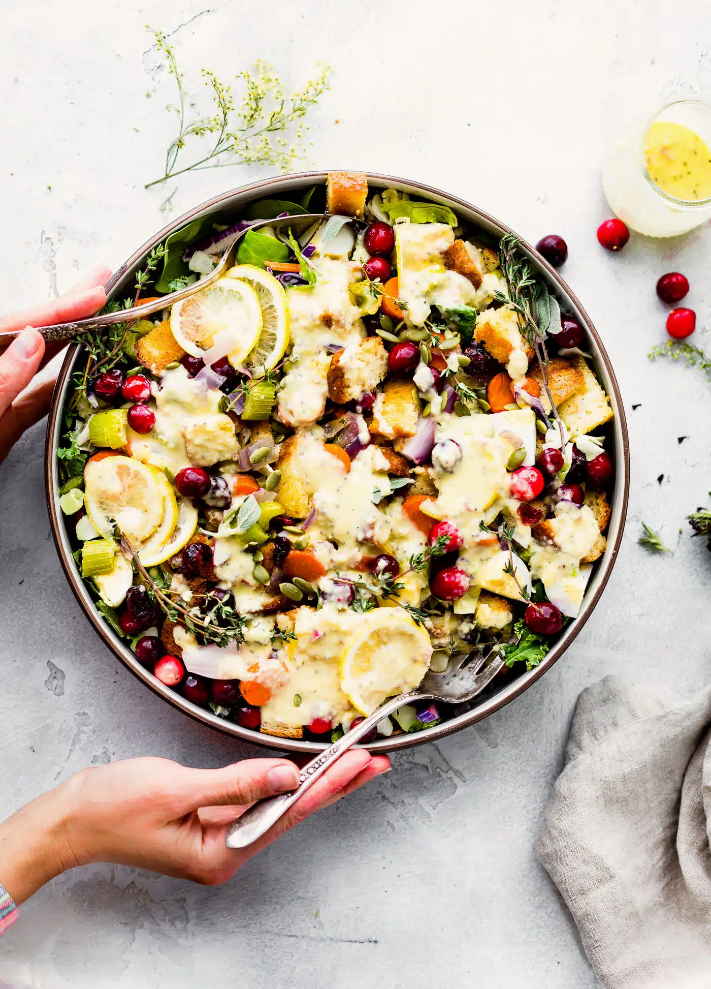 Overhead view gluten free stuffing salad with warm onion dressing in a bowl with a fork. 
