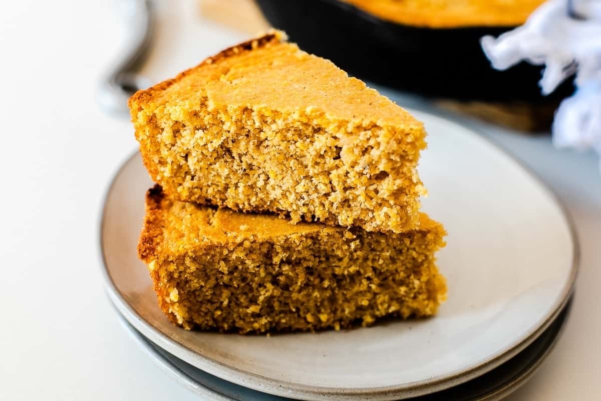 Two slices of pumpkin bread on a white plate.