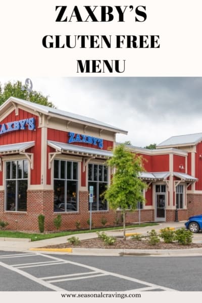 Exterior view of a Zaxby's restaurant with a banner promoting a gluten-free menu, situated near a parking lot under a cloudy sky.