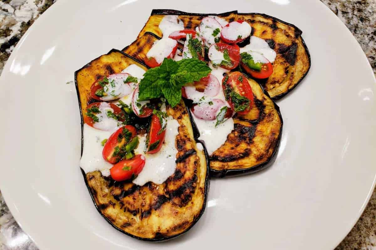 Grilled Eggplant With Tomatoes And Yogurt Sauce.