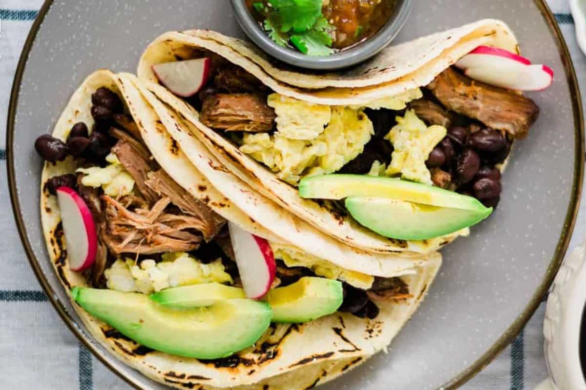 Slow Cooker Pork Carnitas and Eggs Breakfast Tacos.