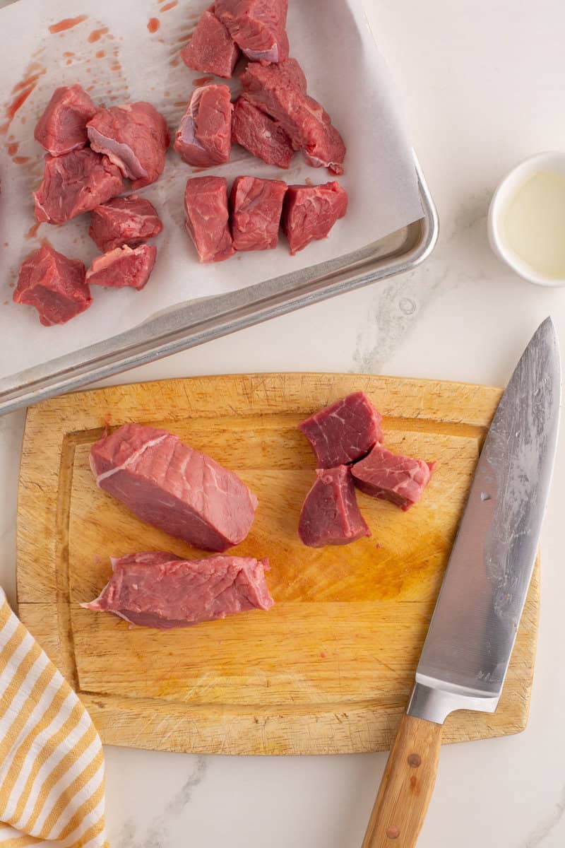 steak tips cut into cubes on cutting board
