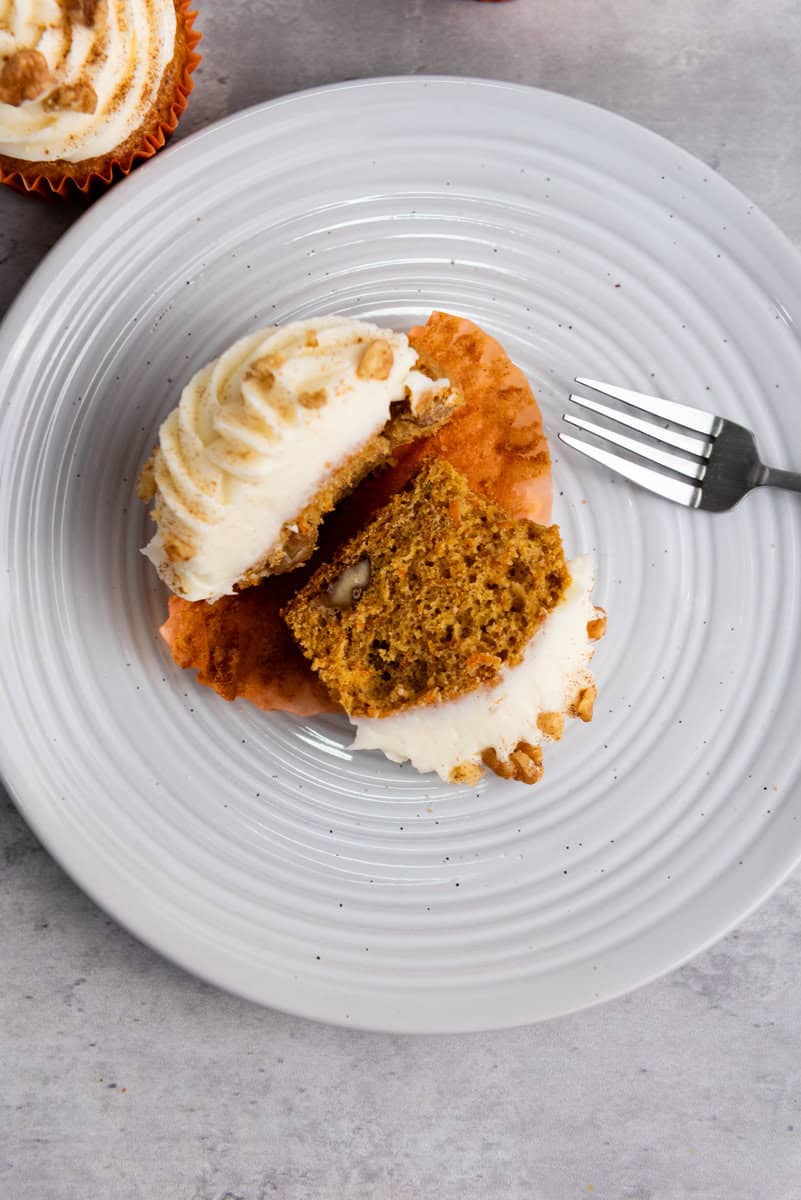 carrot cake muffin cut in half on plate