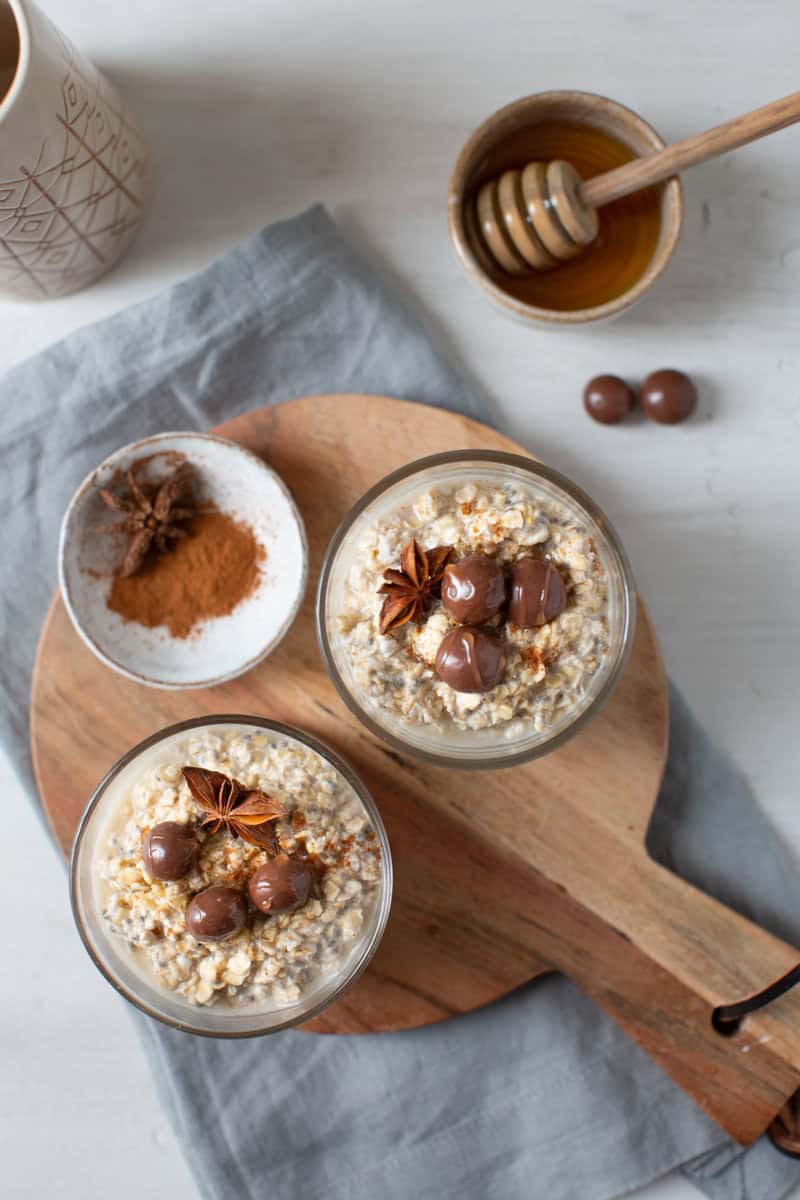 two jars of overnight oats on a wooden board