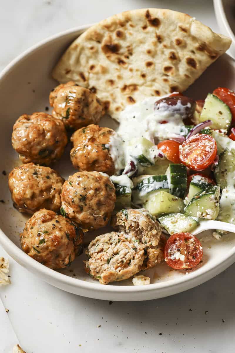 chicken meatballs in a bowl with dressing