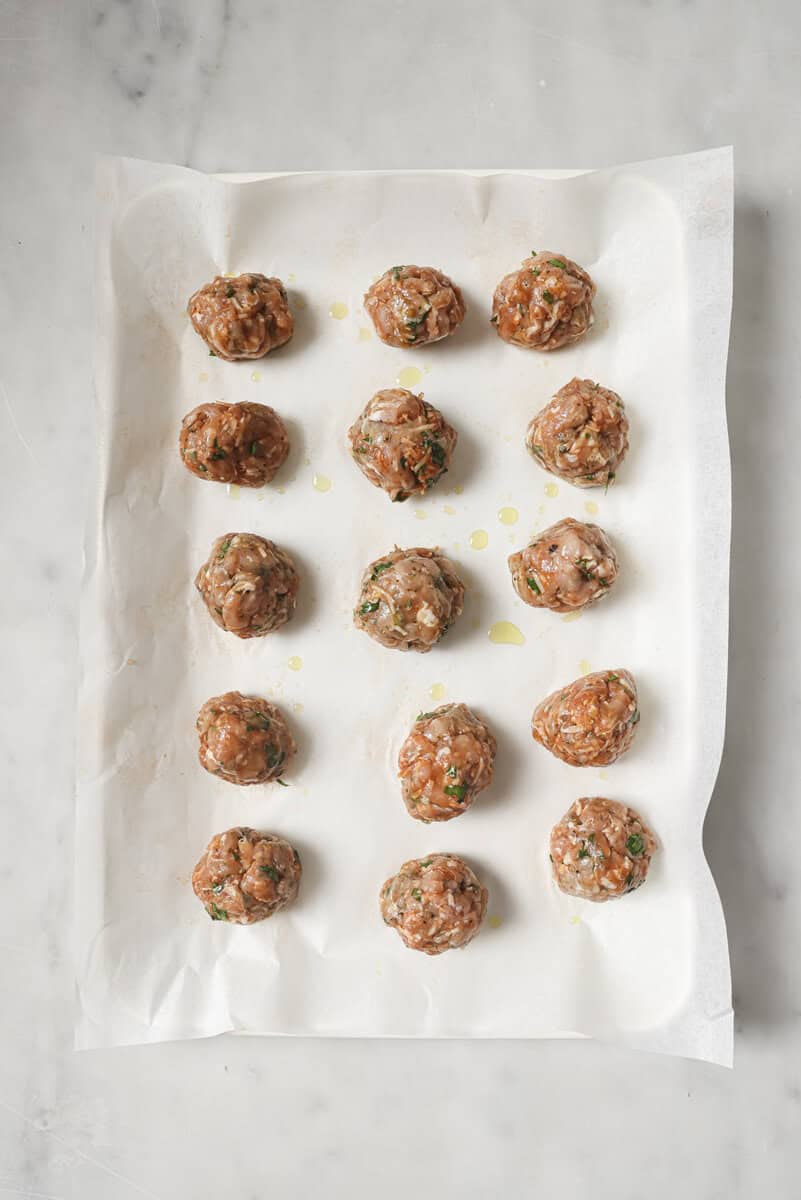 raw meatballs on a sheet pan