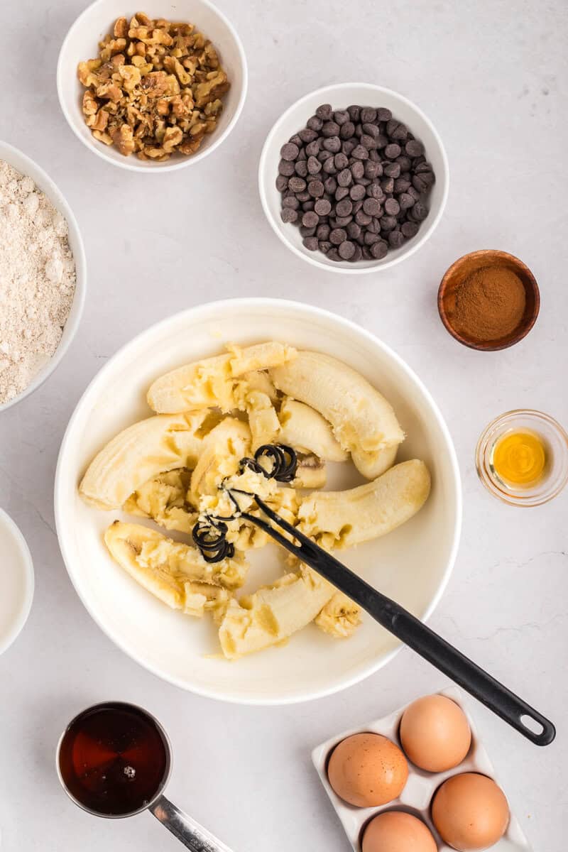 mashed banana in a mixing bowl