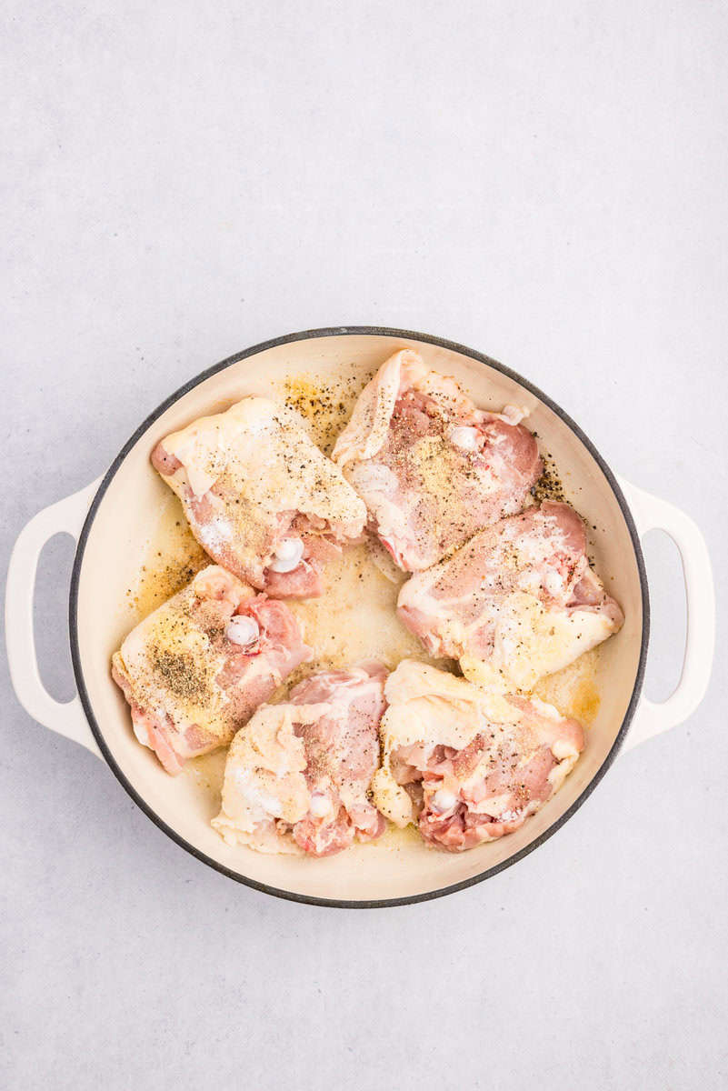 chicken thighs braising in a dutch oven