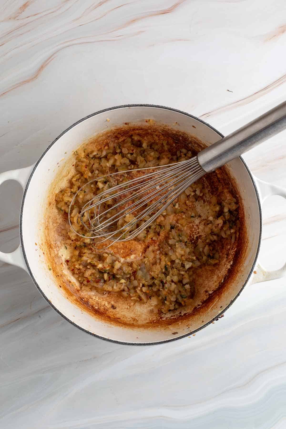 ground sausage and onions sauteing in pan