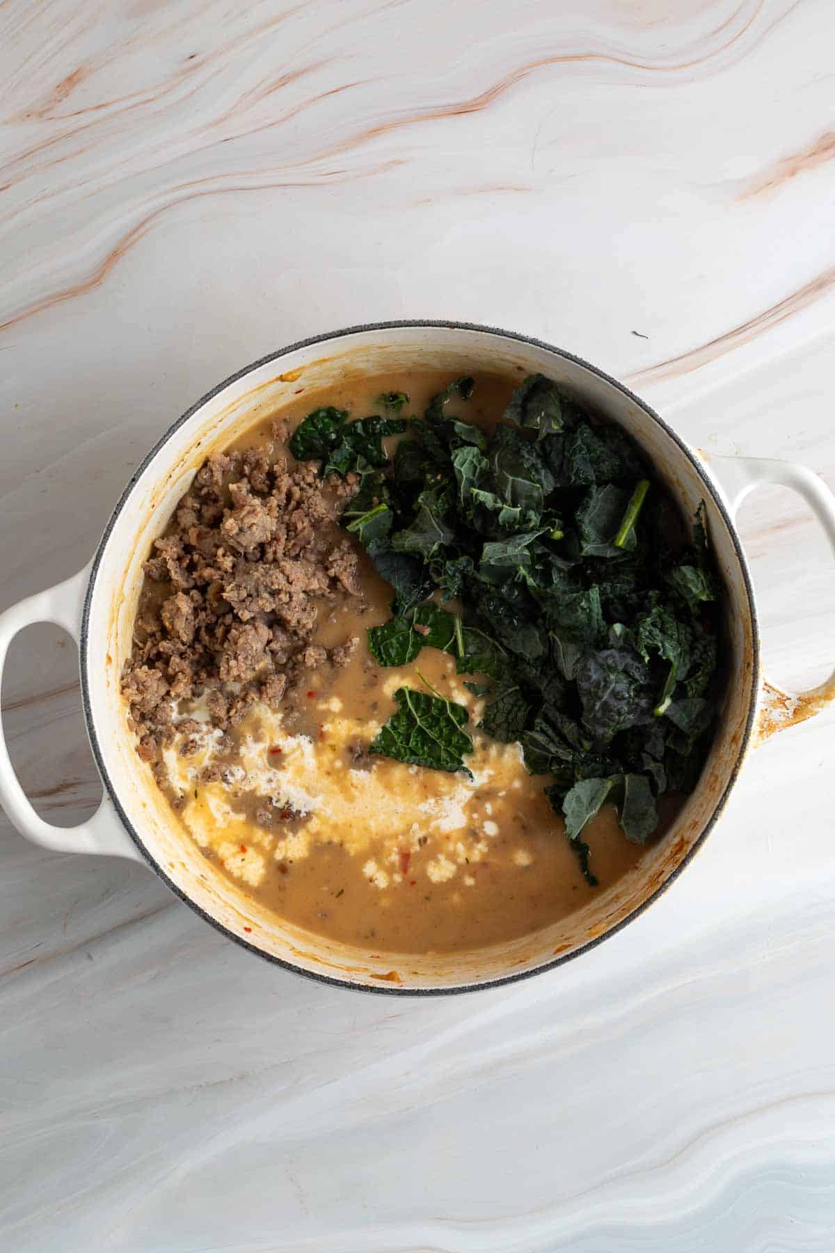 kale, potatoes and sausage in a pot