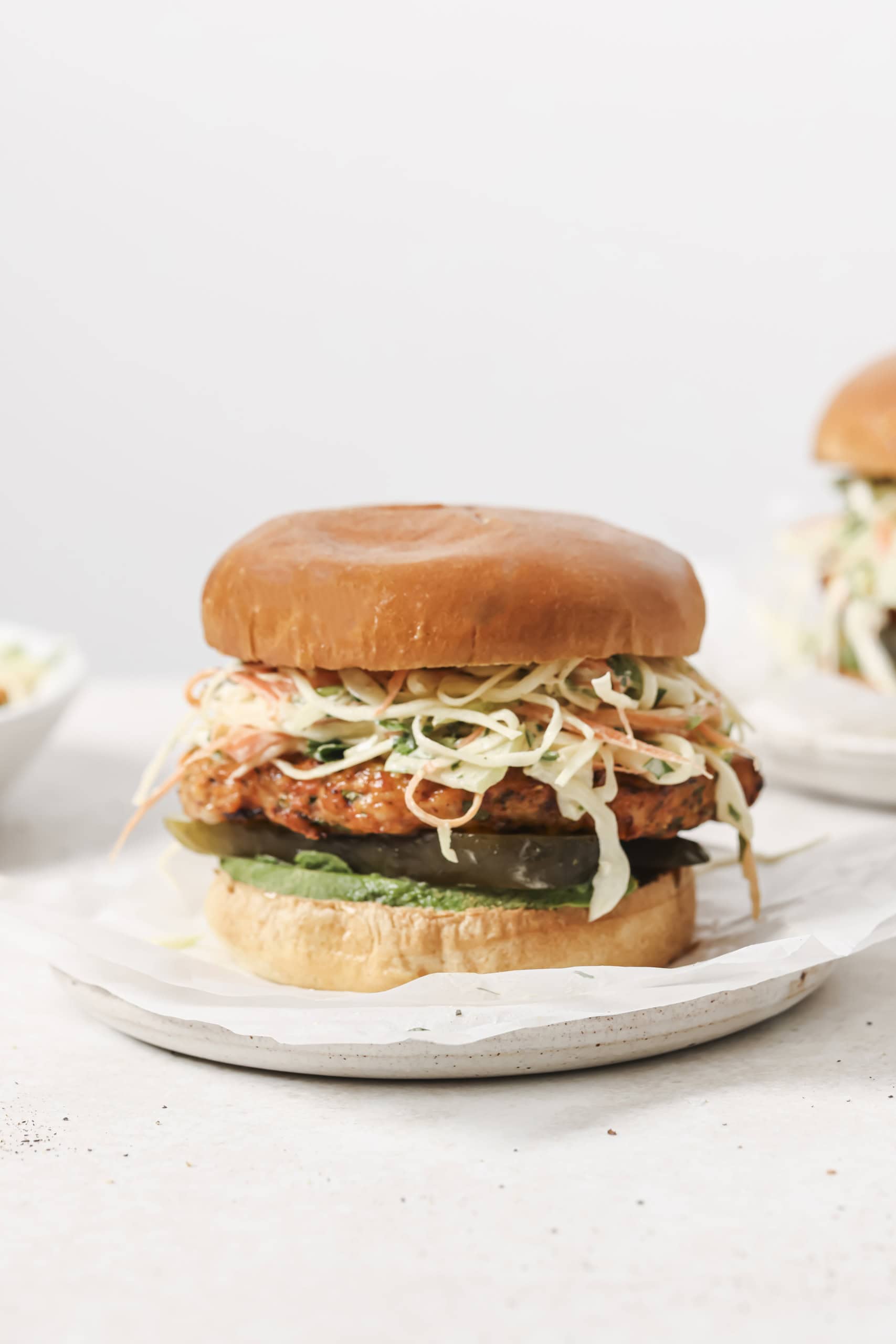 air fryer chicken burger with slaw on a white plate