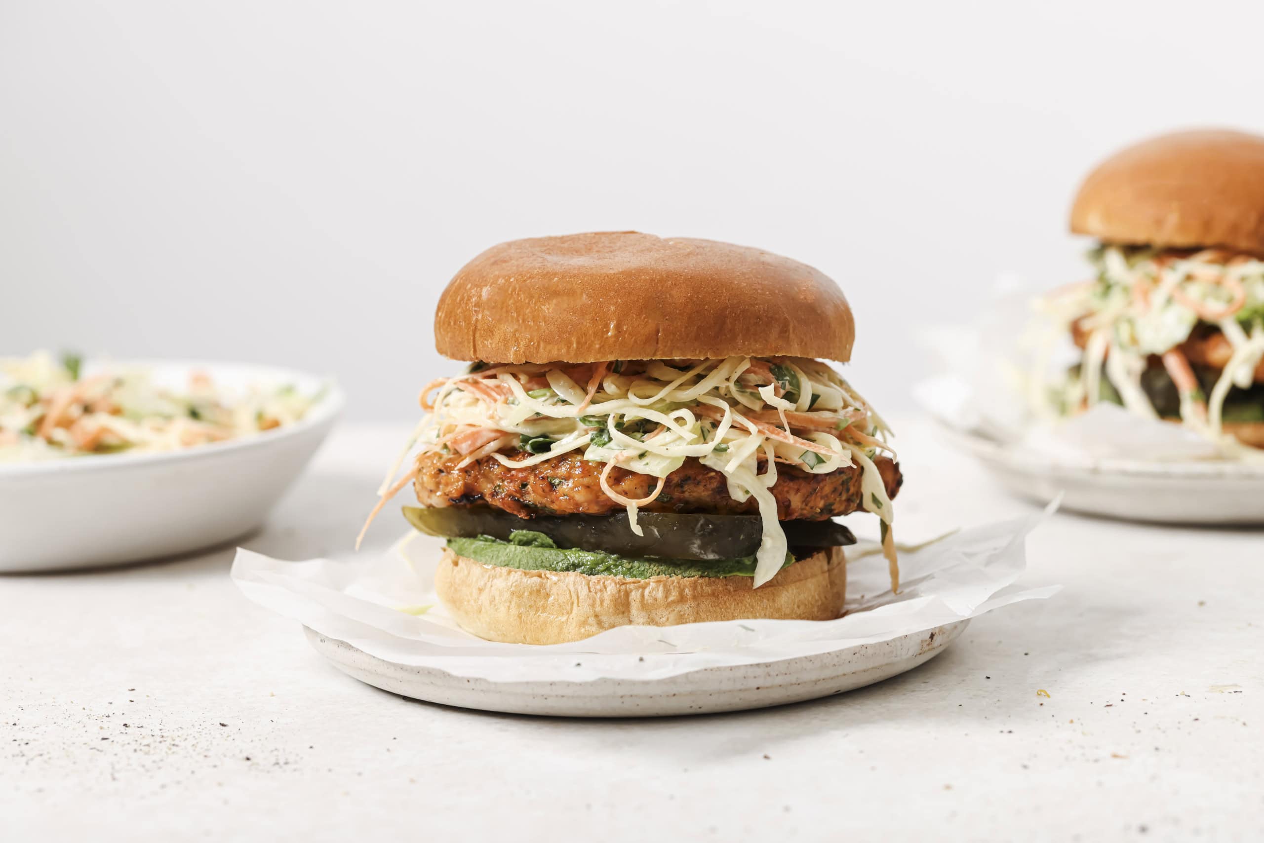 air fryer chicken burger with slaw on a white plate