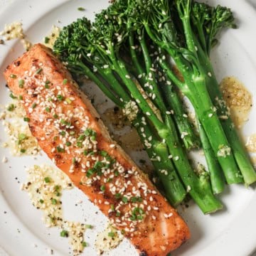 ginger lime salmon on a white plate with broccolini