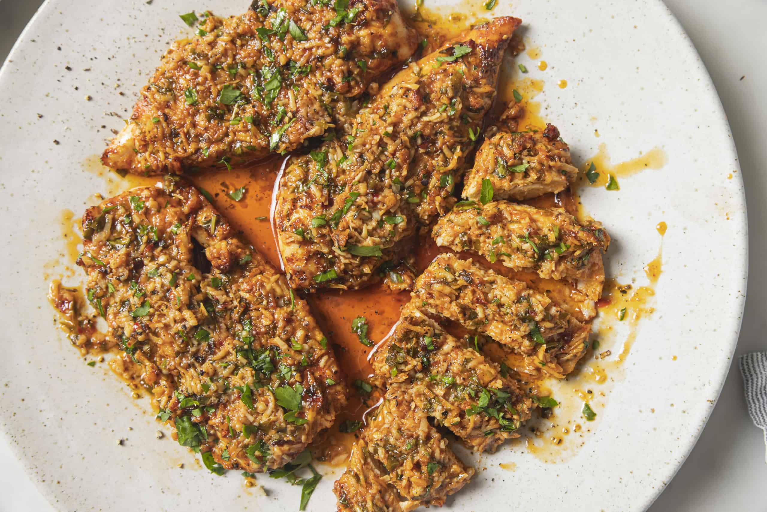 parmesan chicken sliced on a plate