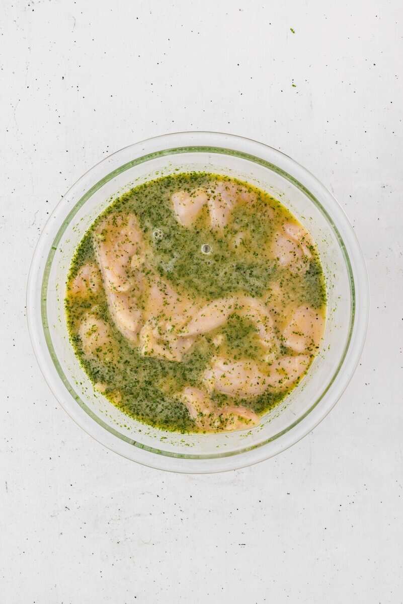 chicken breasts with marinade in a bowl