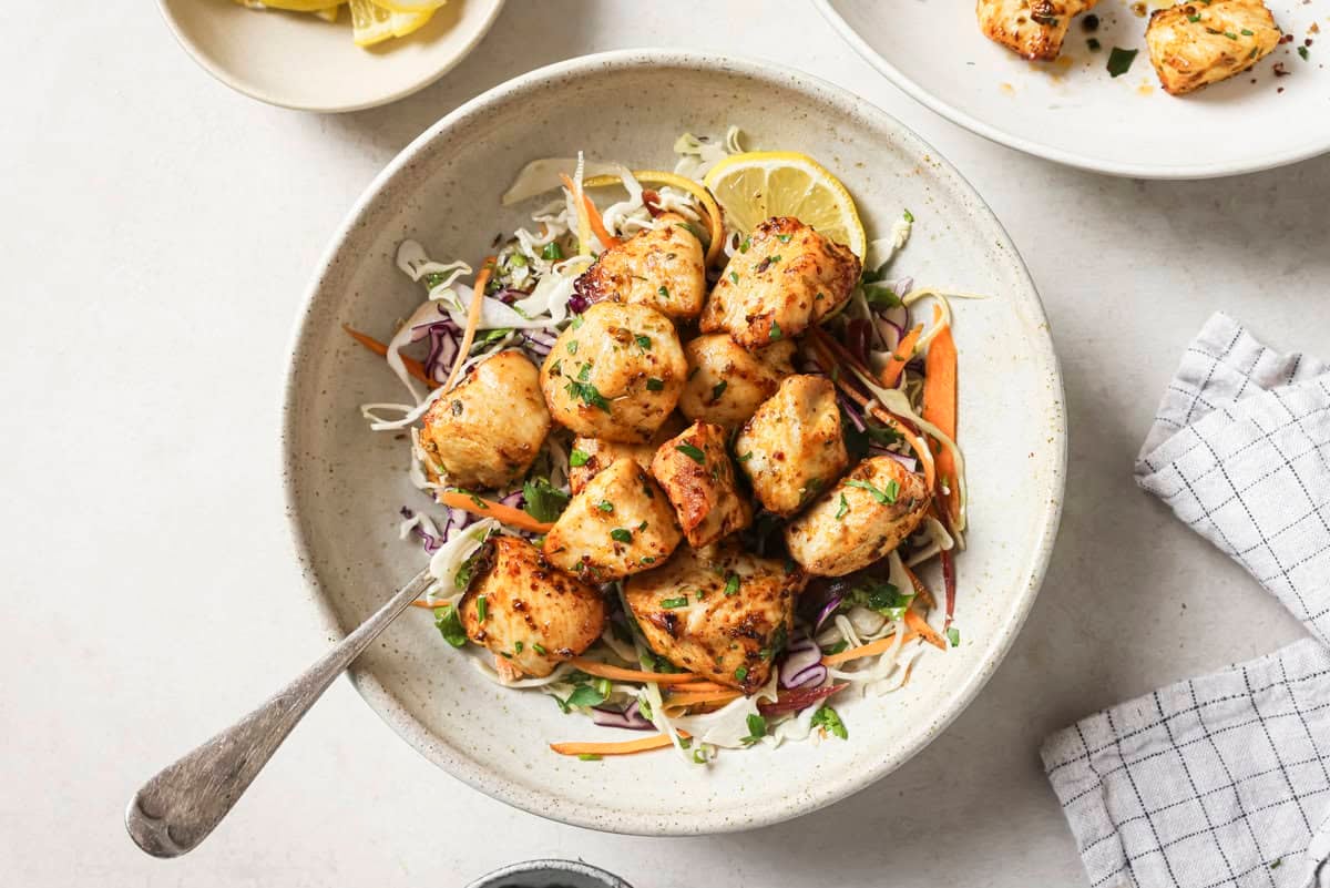 cooked chicken bites on a bed of cabbage