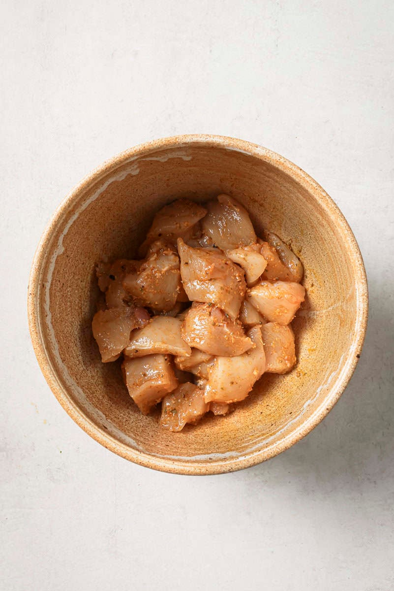 chicken pieces in a bowl covered in marinade