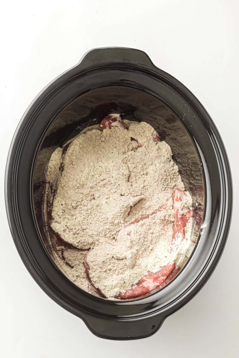 flour in crock pot with pork roast