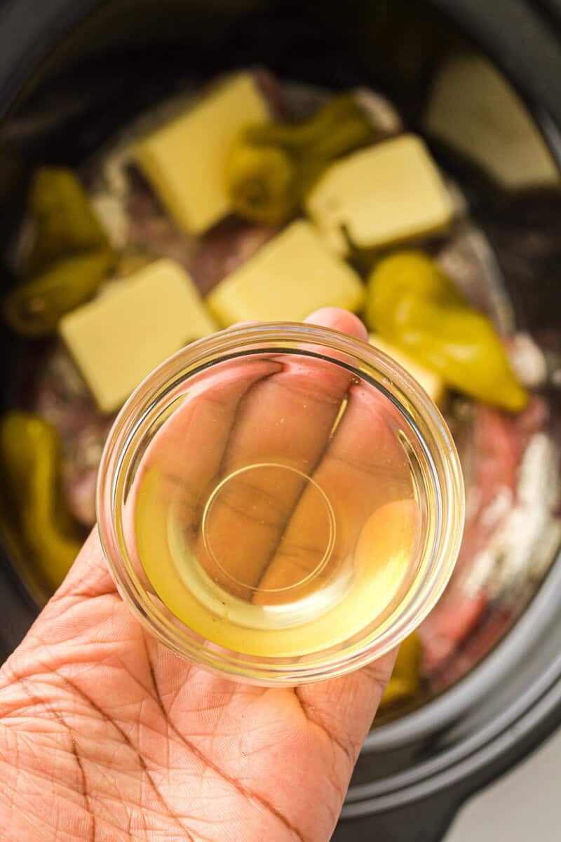 oil going into crock pot with pork roast