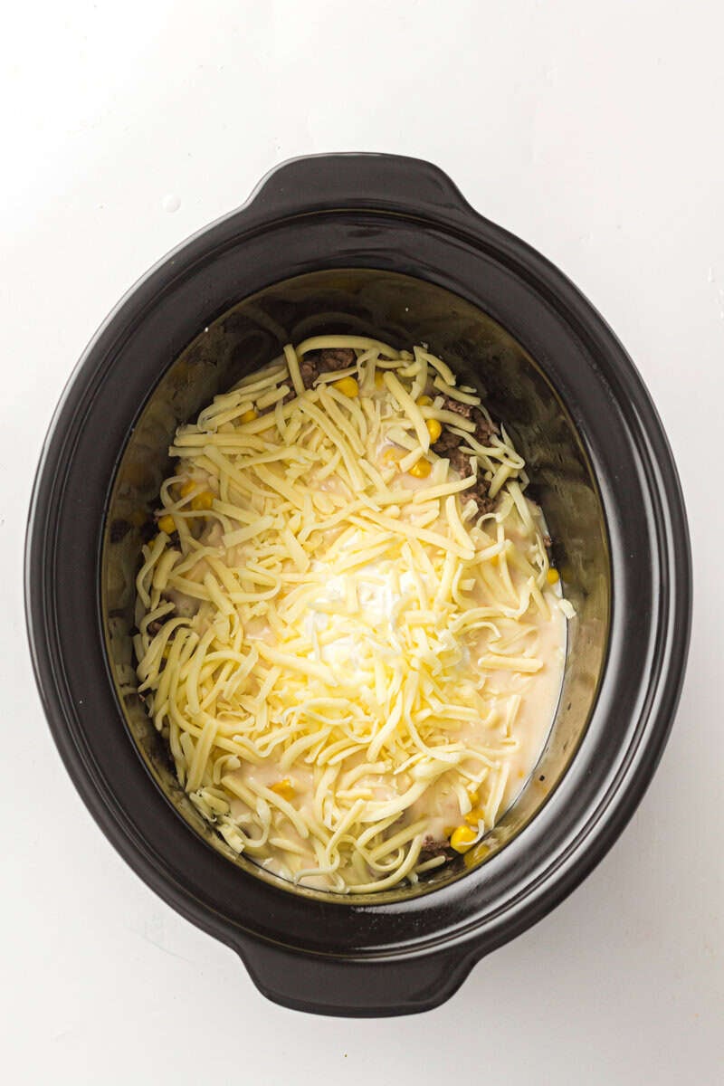 cheese and ingredients in slow cooker