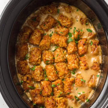 Savory slow cooker chicken and rice casserole in a black crockpot.