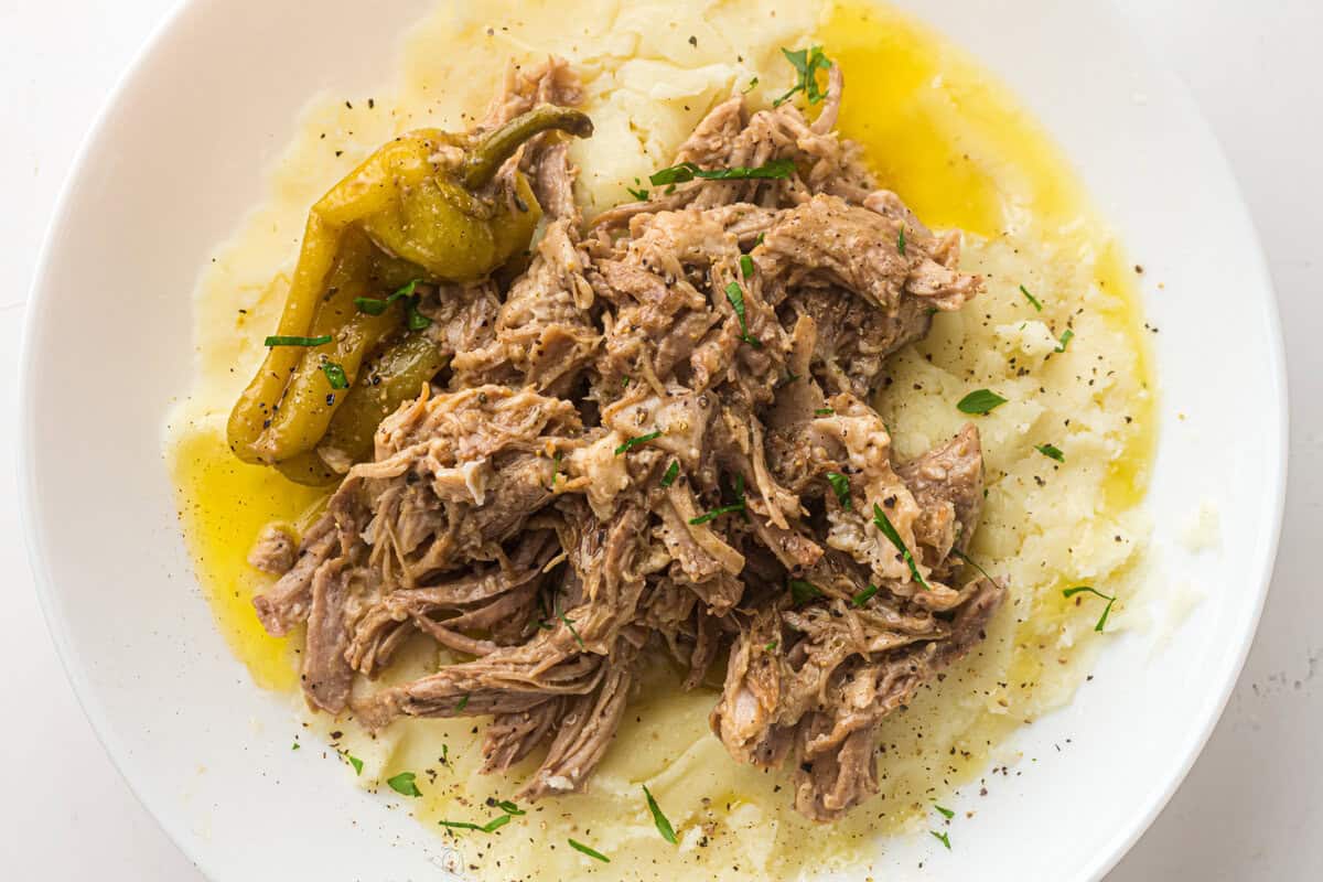 mississippi pork roast on a plate with mashed potatoes