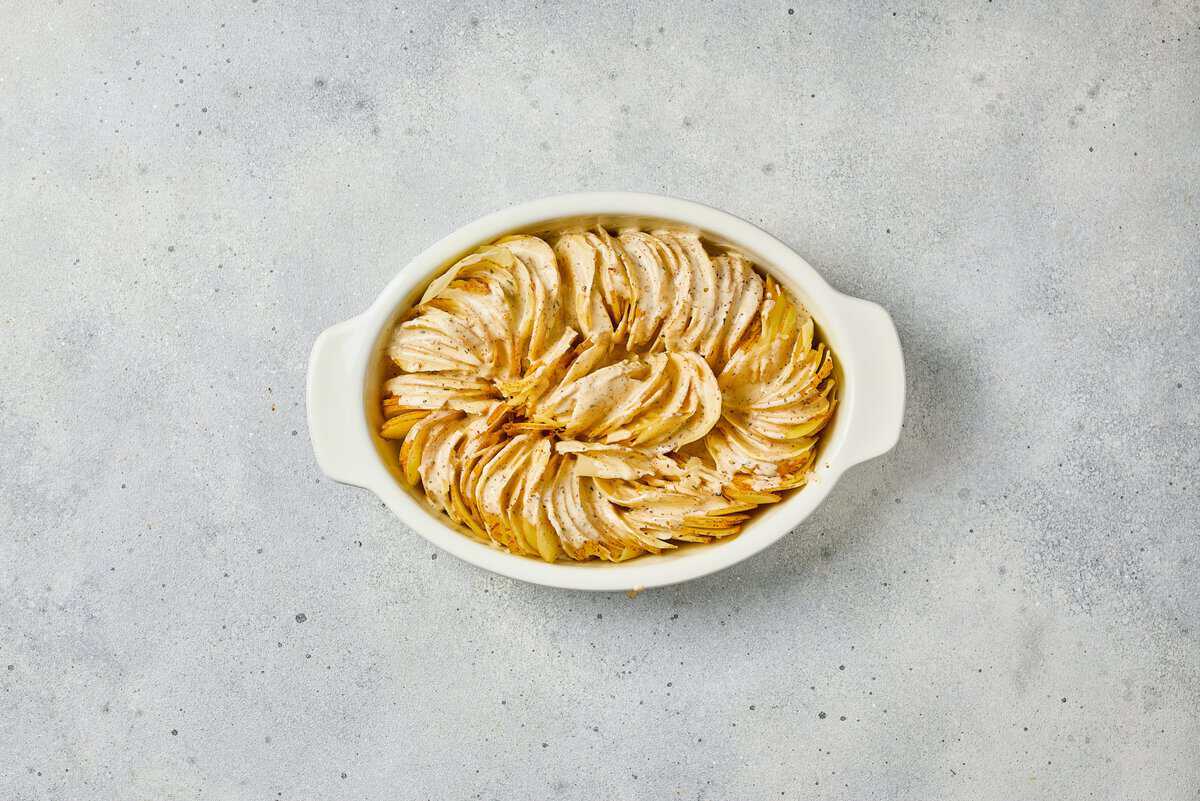 sliced potatoes arranged upright in casserole dish