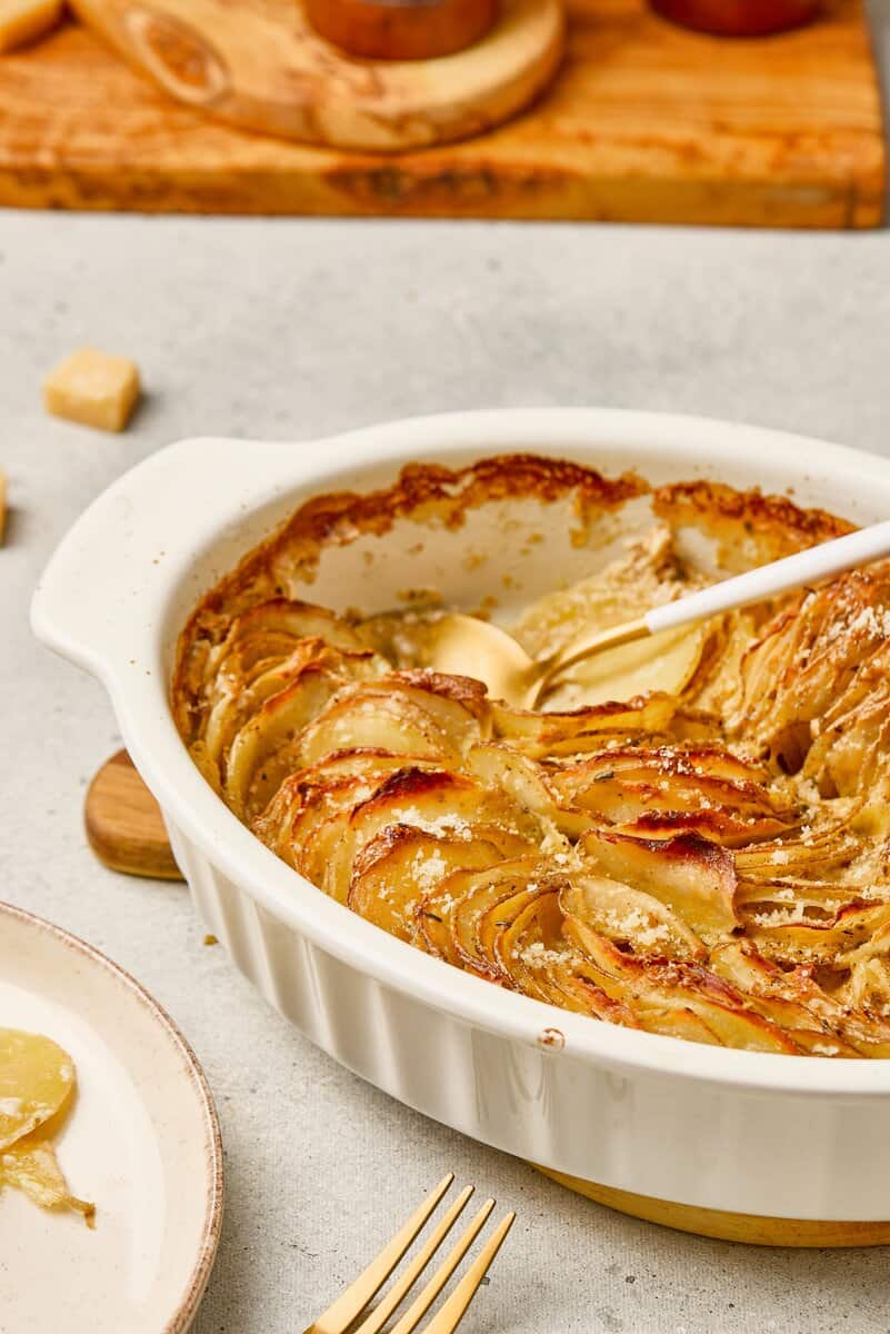 scalloped potatoes with a serving spoon