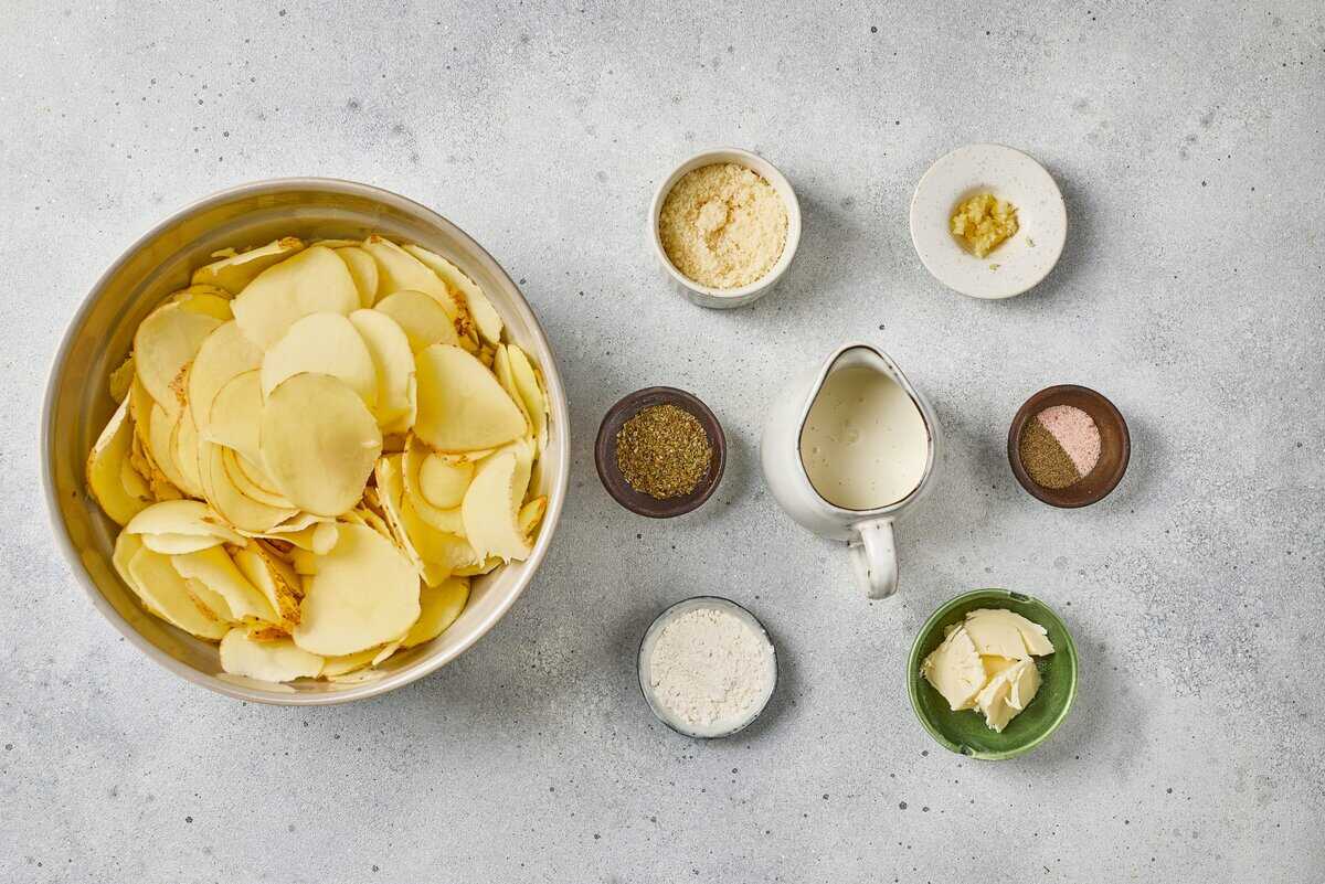 ingredients to make scalloped potatoes including butter salt and pepper