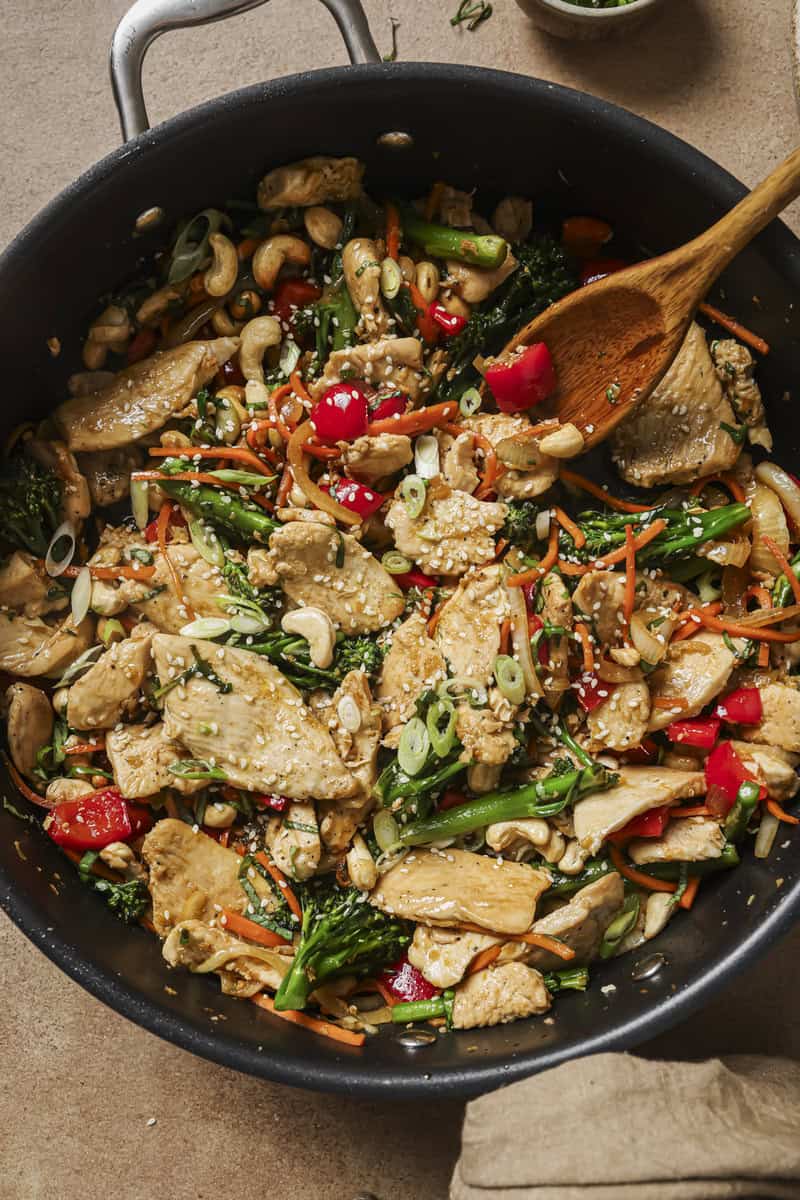 basil chicken stir fry with cashews in skillet