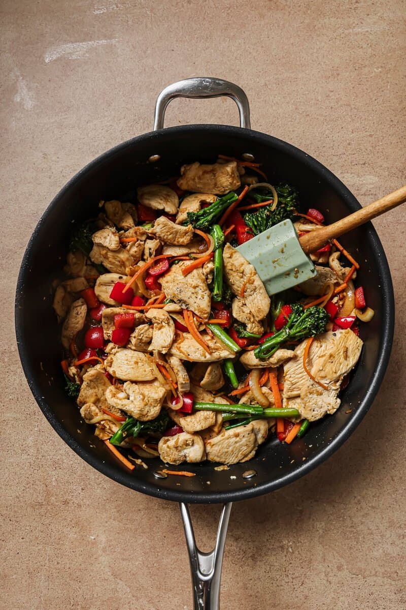 chicken added to skillet with vegetables 