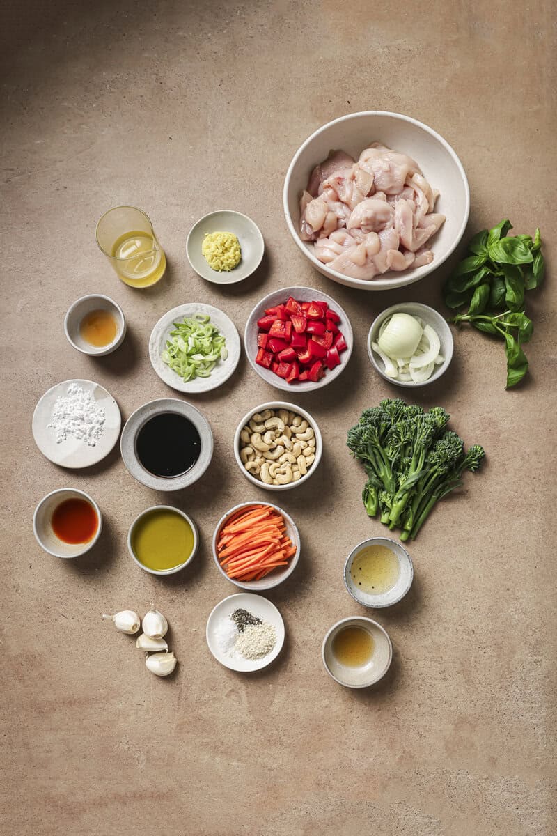 ground chicken and vegetables in small bowls for basil chicken stir fry