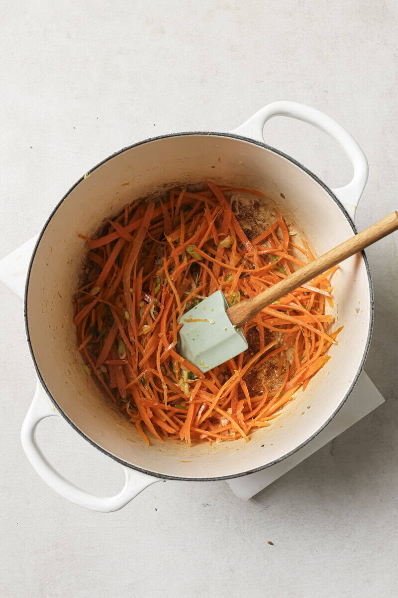 carrots added to dutch oven with vegetables 