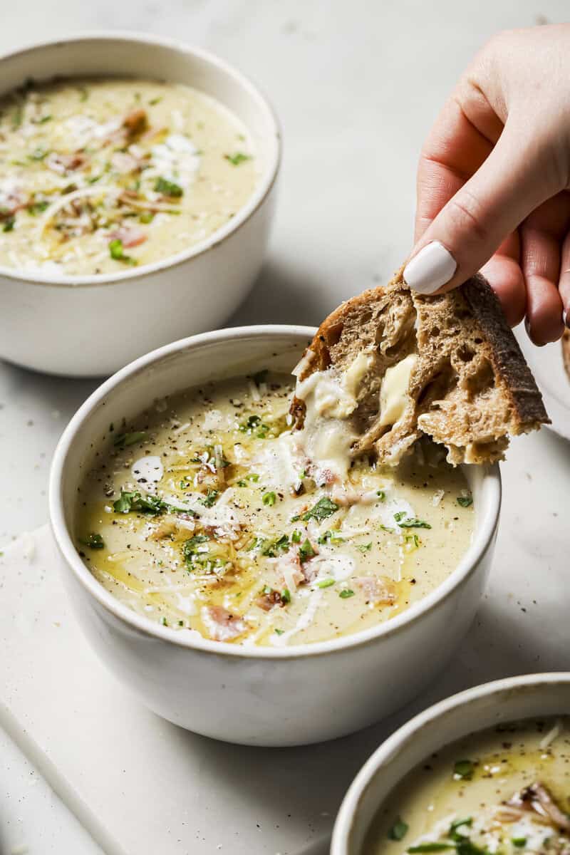 slow cooker potato soup with buttered bread on the side