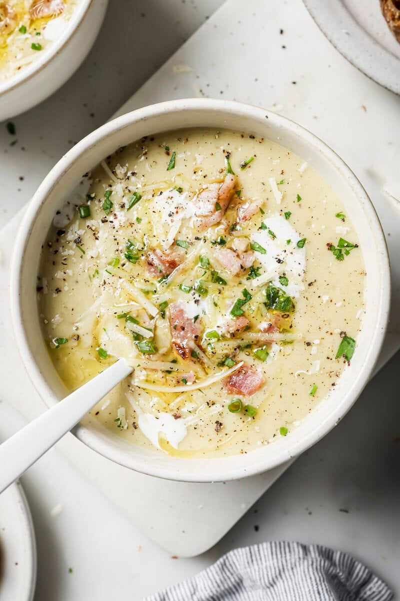 slow cooker potato soup in a bowl with toppings