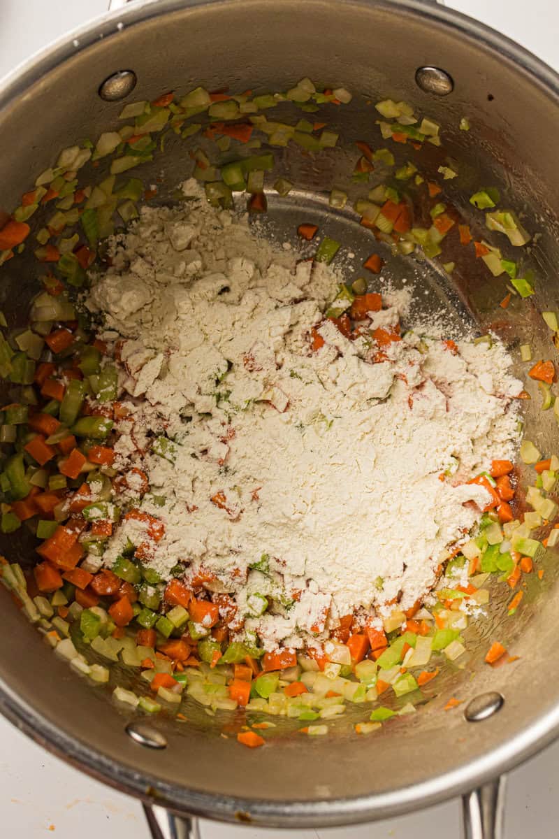 flour added to vegetables in a pot