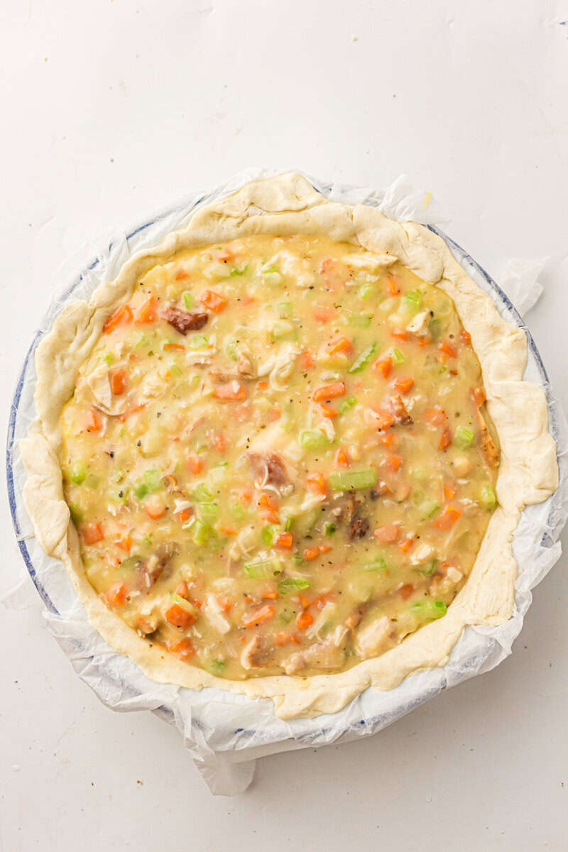 chicken and vegetable filling put into crust