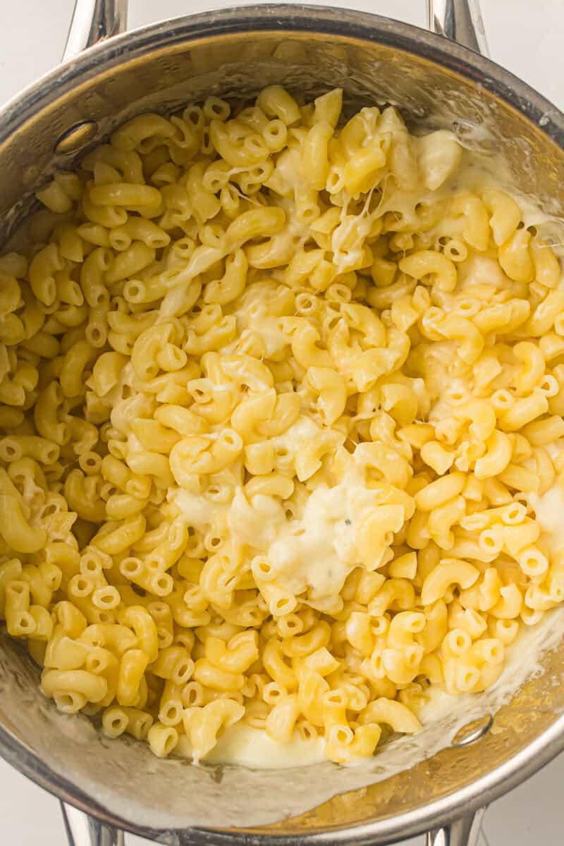 cheese sauce added to macaroni noodles
