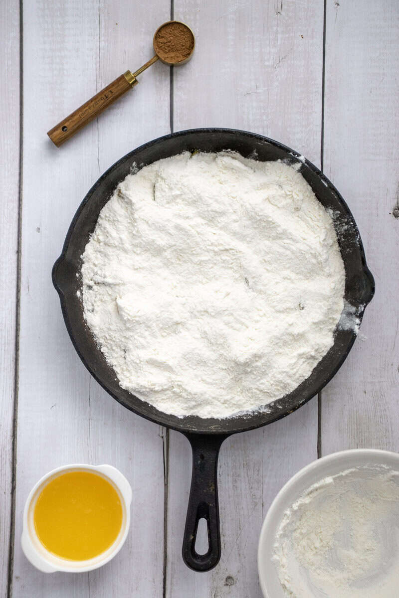 flour on top of peaches in skillet