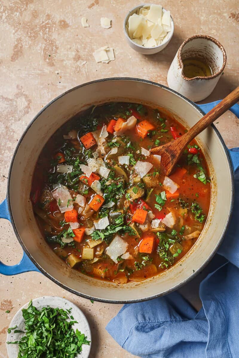 finished soup in pot with wooden spoon