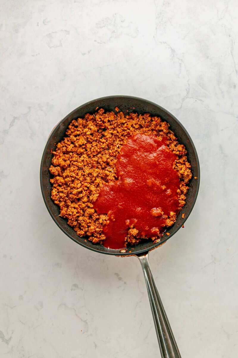 ground chorizo in a pan with cream and cheese