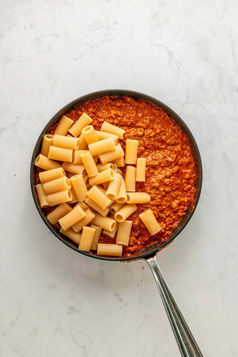 pasta added to pan with cream cheese and tomato sauce