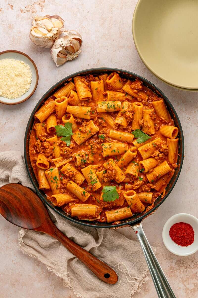 Creamy Chorizo Pasta in a pan with cheese on the side