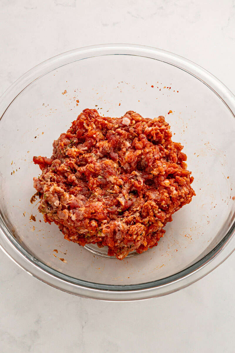 ground beef in bowl mixed with spices