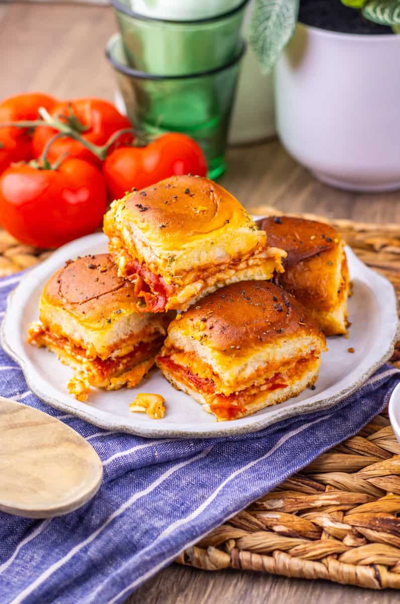 pizza sliders stacked up on a plate