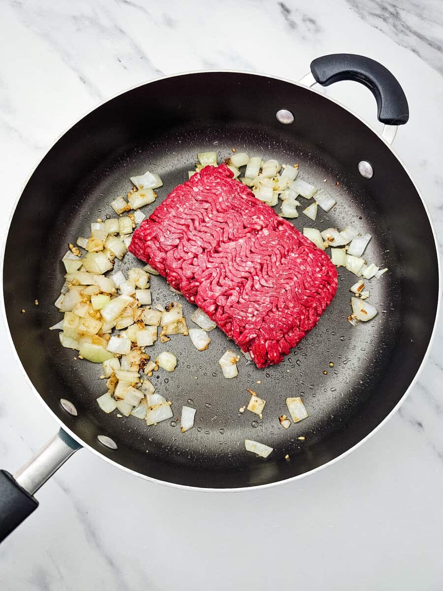 ground beef and onions and garlic in skillet