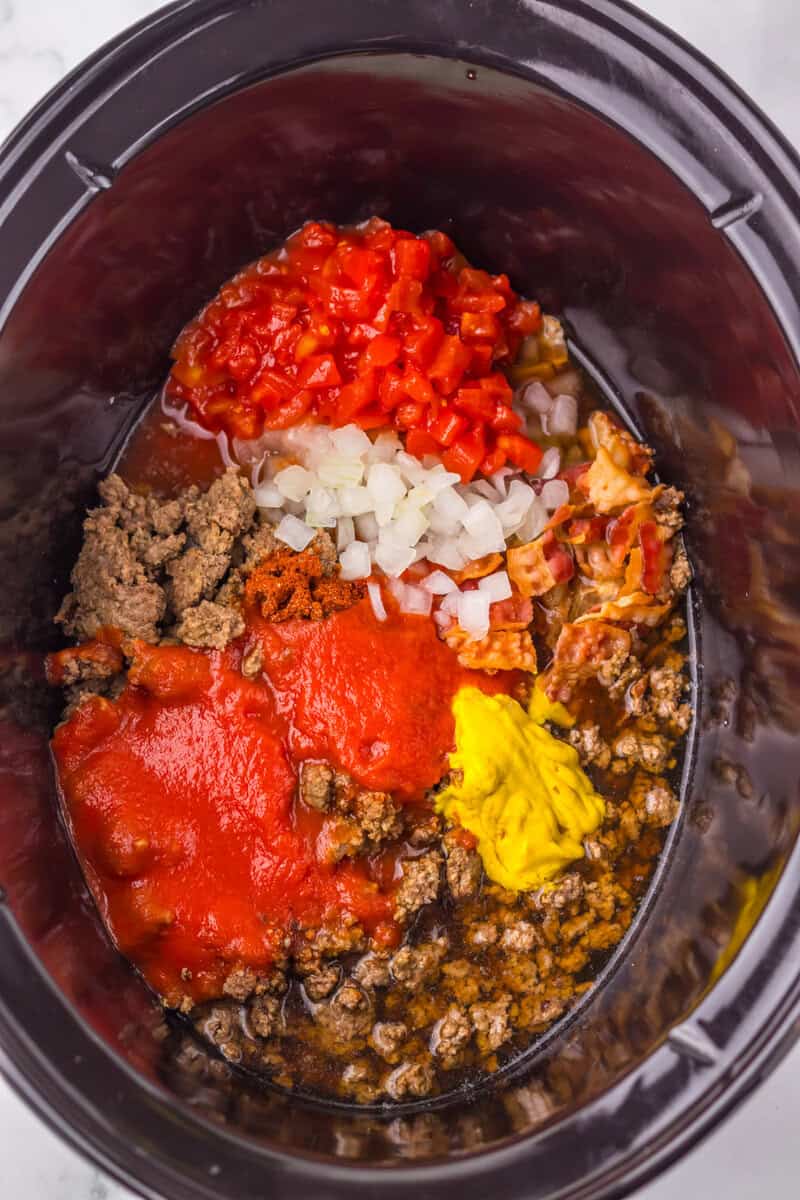 Pour in the beef broth, tomato sauce, and mustard, then stir until everything is evenly combined.