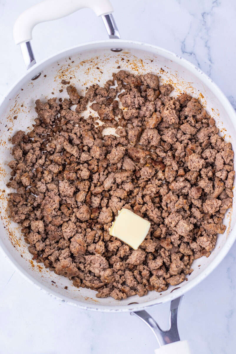 ground beef with butter in a skillet