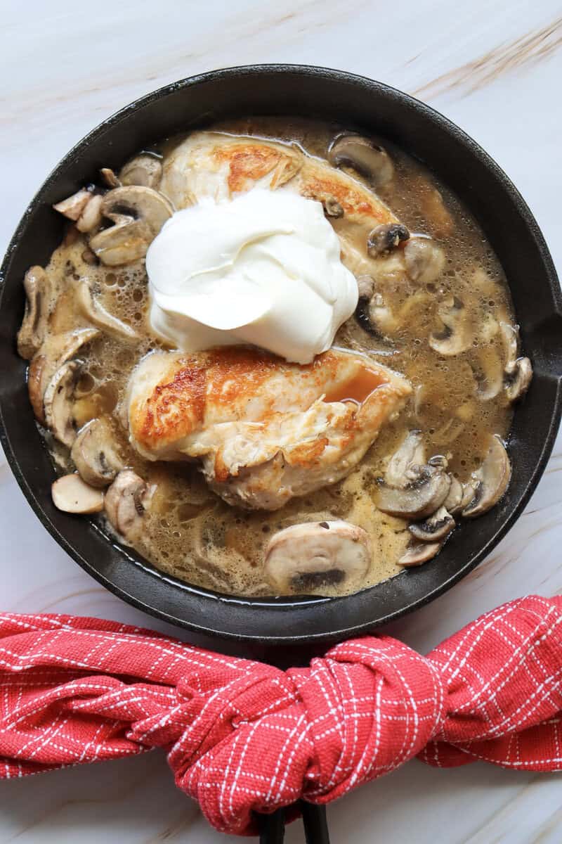 sour cream added to skillet with Mushroom White Wine Marry Me Chicken